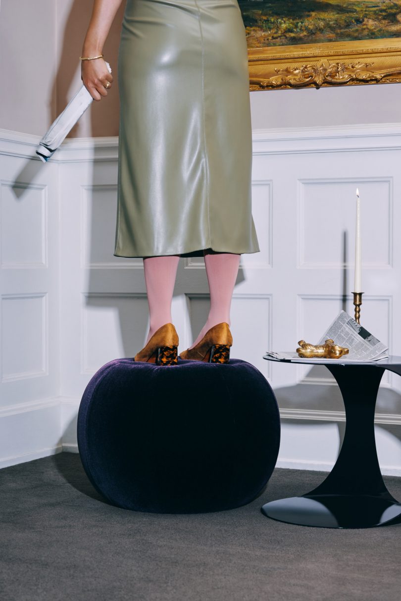 Woman Standing On Toof Ottoman 