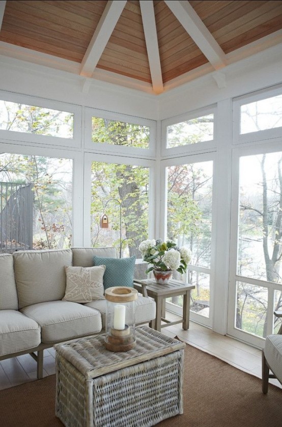 A Beach Sunroom Nook With A Blue And Neutral L-Shaped Bench And Comfy Cushions And Pillows Is Lovely