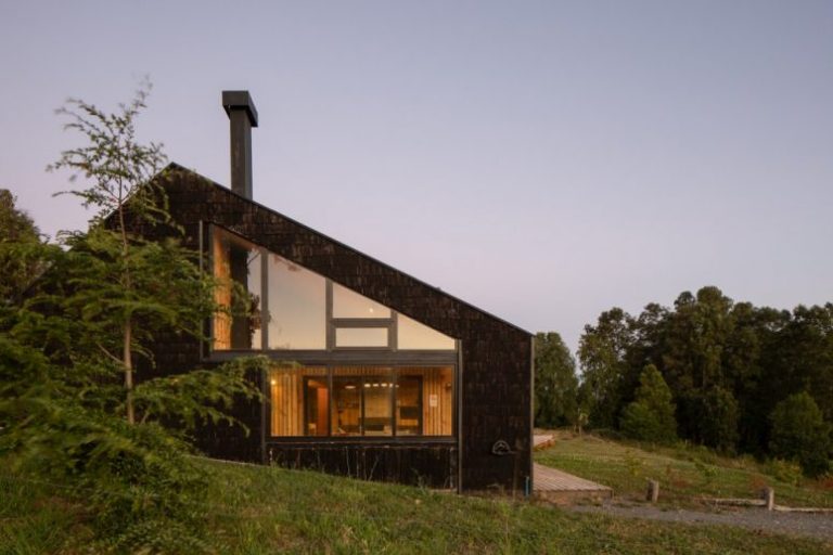 This house in Chile is a simple and modern dwelling with a view of the lake and distant volcanos and it's almost completely built of wood