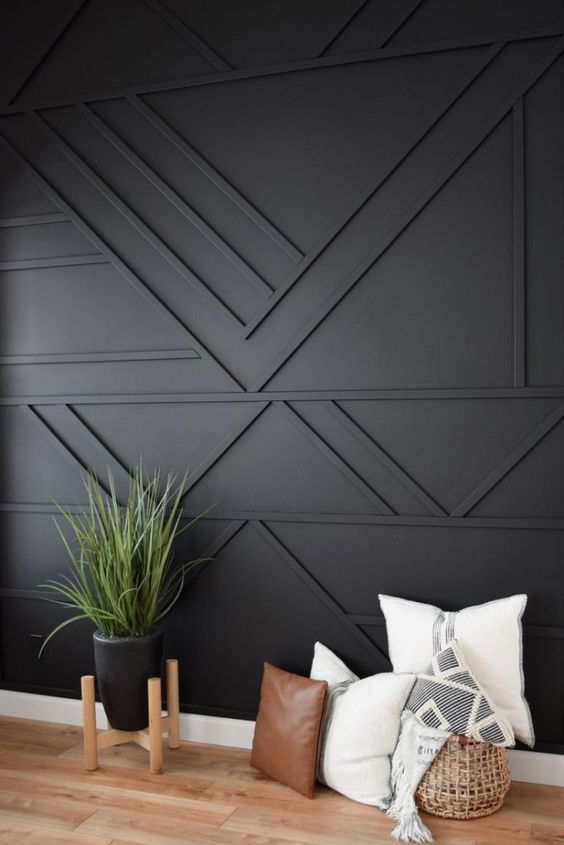 a black geometric paneled wall is a cool solution for a boho, mid-century modern and just elegant contemporary space