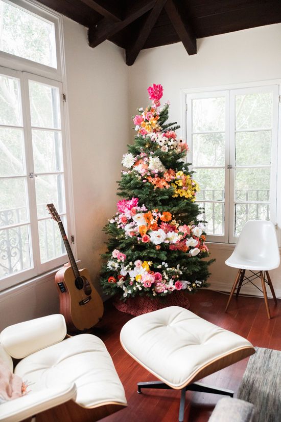 a Christmas tree decorated with blooms and lights is a unique boho chic idea to arise your inner flower child