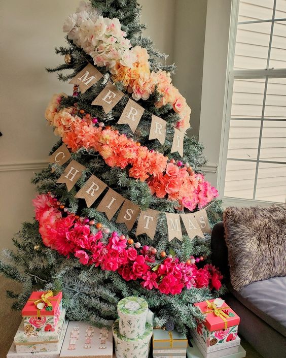 a fantastic ombre Christmas tree decorated with an ombre faux floral garland and colorful wooden beads is a lovely and bold idea