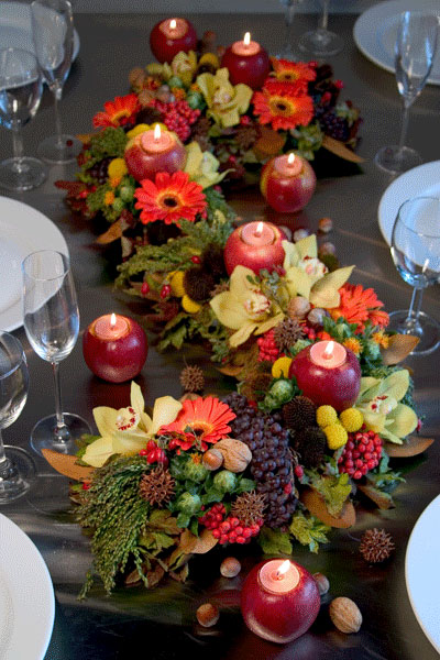 a very simple last minute Thanksgiving or fall centerpiece of a box with greenery and some fall leaves and apples around is very cool