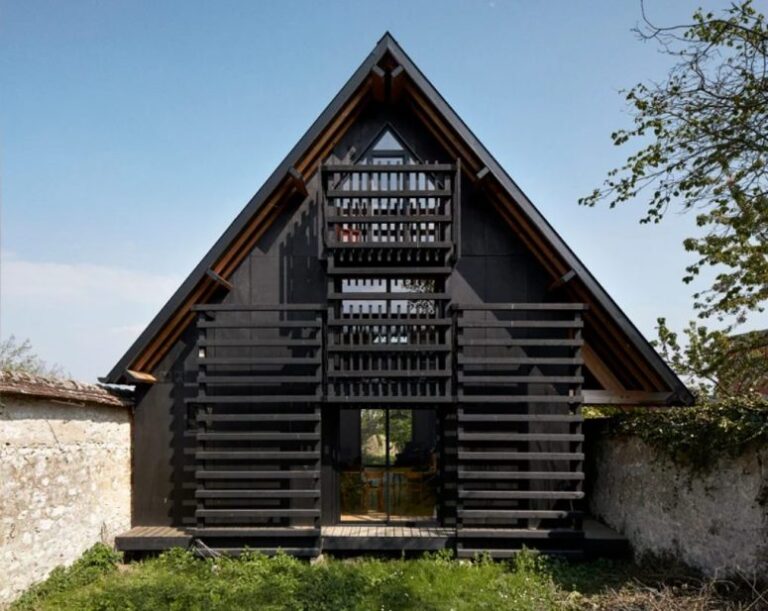 This house in rural France was built between the walls of an existing one and was painted black for a modern feel